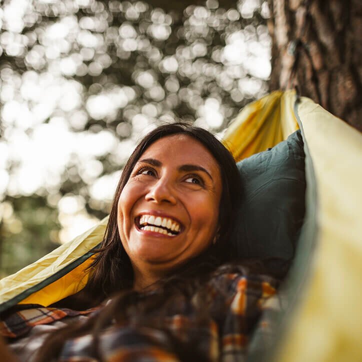 Woman fills up vitamin D in the sun in hammock