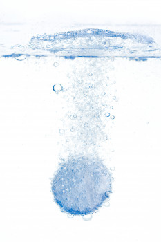 La pastilla efervescente burbujea en el agua