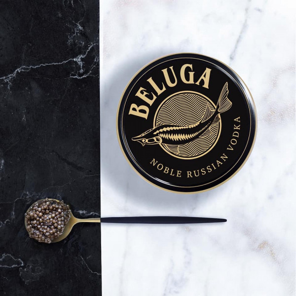 Beluga caviar tin and caviar on spoon